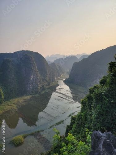View from top of mountain over lake and rice field kong skull island