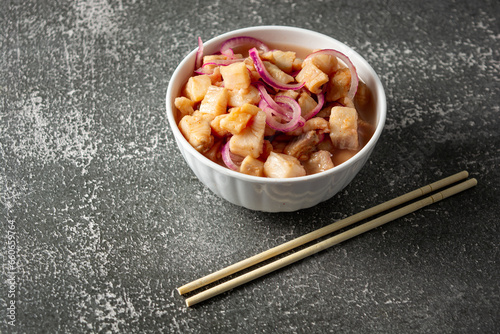 fish ceviche with onions and pepper. traditional peruvian food with tigra milk photo