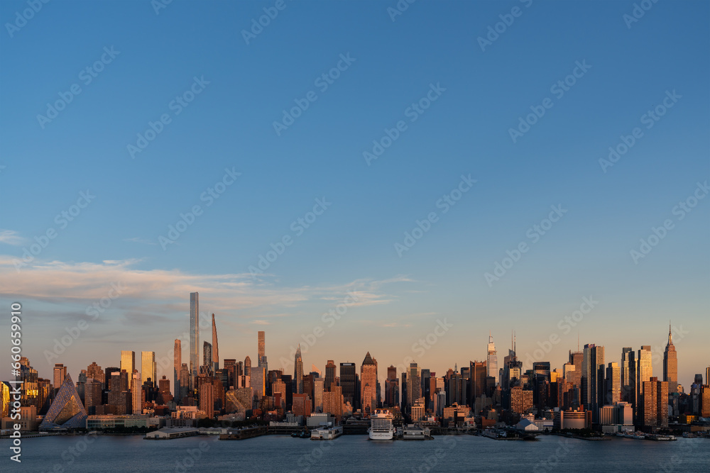 Aerial New York City skyline from New Jersey over the Hudson River with the skyscrapers at sunset. Manhattan, Midtown, NYC, USA. A vibrant business neighborhood
