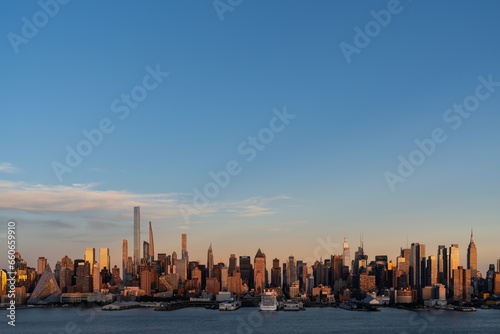 Aerial New York City skyline from New Jersey over the Hudson River with the skyscrapers at sunset. Manhattan, Midtown, NYC, USA. A vibrant business neighborhood