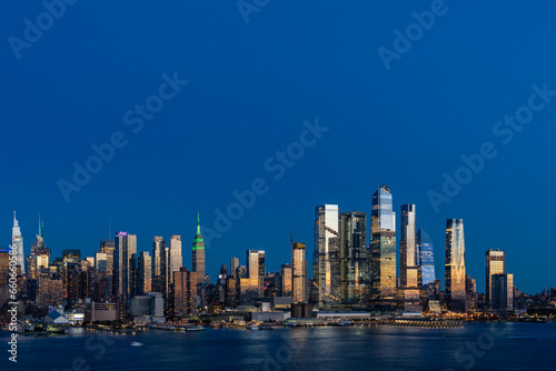 Aerial New York City skyline from New Jersey over the Hudson River with the skyscrapers of the Hudson Yards district at night. Manhattan, Midtown, NYC, USA. A vibrant business neighborhood © VideoFlow