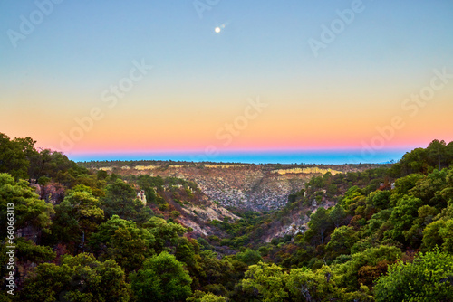 valley at sunset with beautiful colors in the sky, deciduos low forest in monte escobedo zacatecas  photo