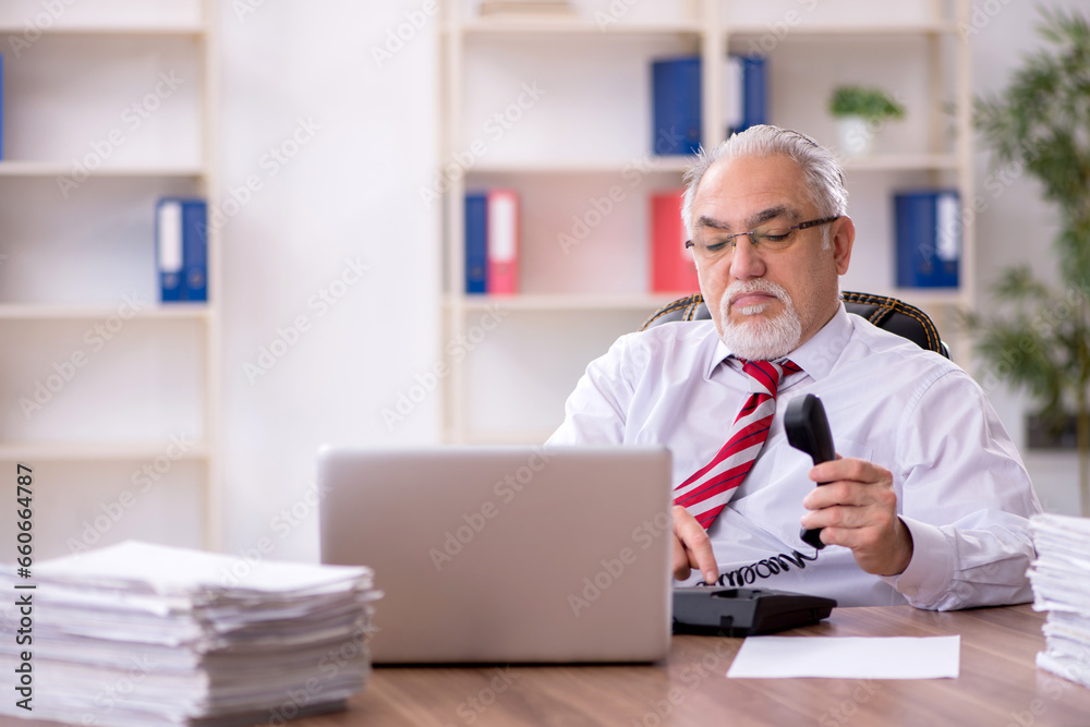 Old male employee and too much work in the office Old male employee and too much work in the office