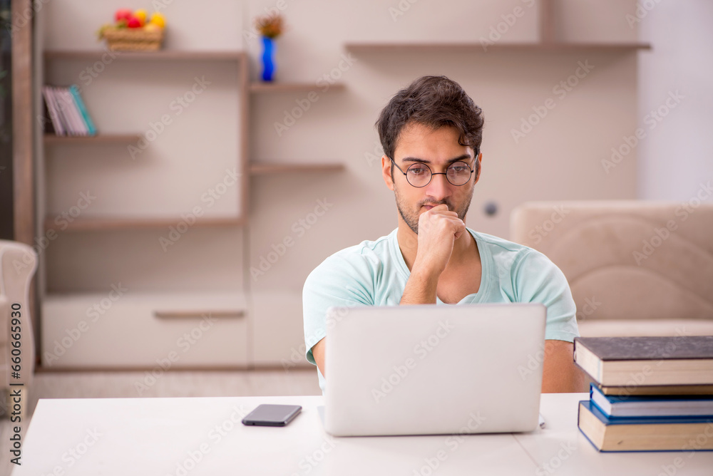 Young male student preparing for exams at home Young male student preparing for exams at home