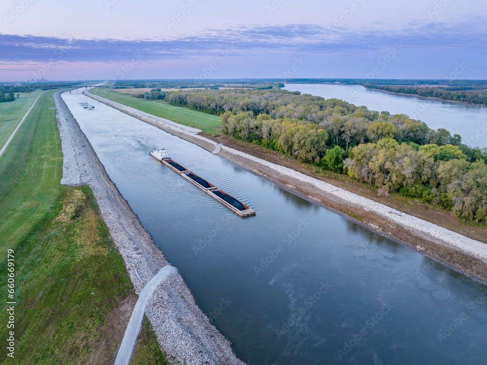 towboats with barges on Chain of Rock Canal of Mississippi River above St Louis, aerial view in October scenery