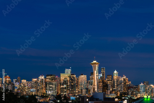 Seattle skyline panorama with iconic view observation tower as seen from Kerry Park. Skyscrapers of financial downtown at night, Washington, USA. A vibrant business neighborhood
