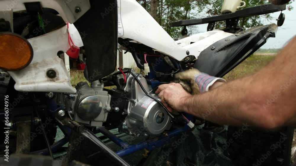 custom made wallpaper toronto digitalClose up while tightening bolts after inhaling new gas motor into ATV or for wheeler after vehicle overheated.