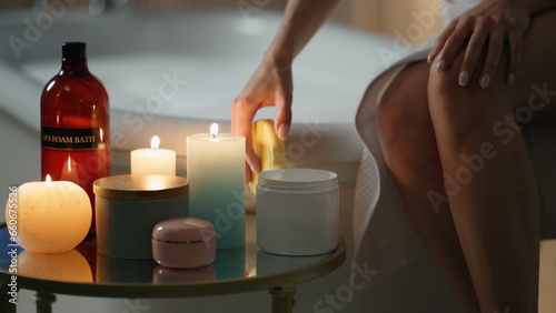 Girl moisturizing hands evening room closeup. Relaxed woman applying skin cream