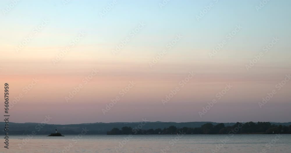 lighthouse on a small island at dusk under a pink and blue sky over Lake Ontario lighthouse on a small island at dusk under a pink and blue sky over Lake Ontario
