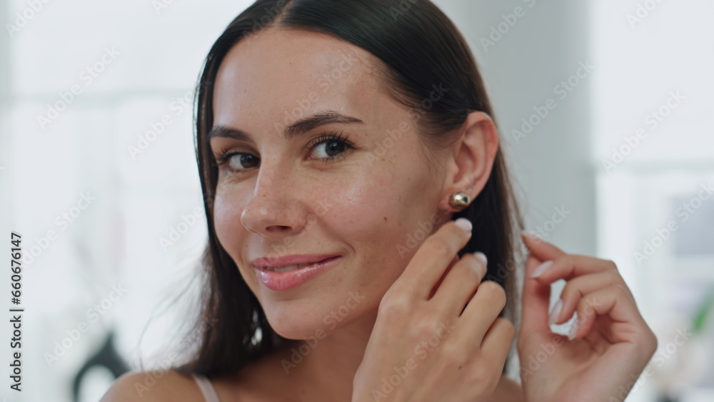 Happy model putting earrings home pov video. Satisfied woman straightening hair Happy model putting earrings home pov video. Satisfied woman straightening hair