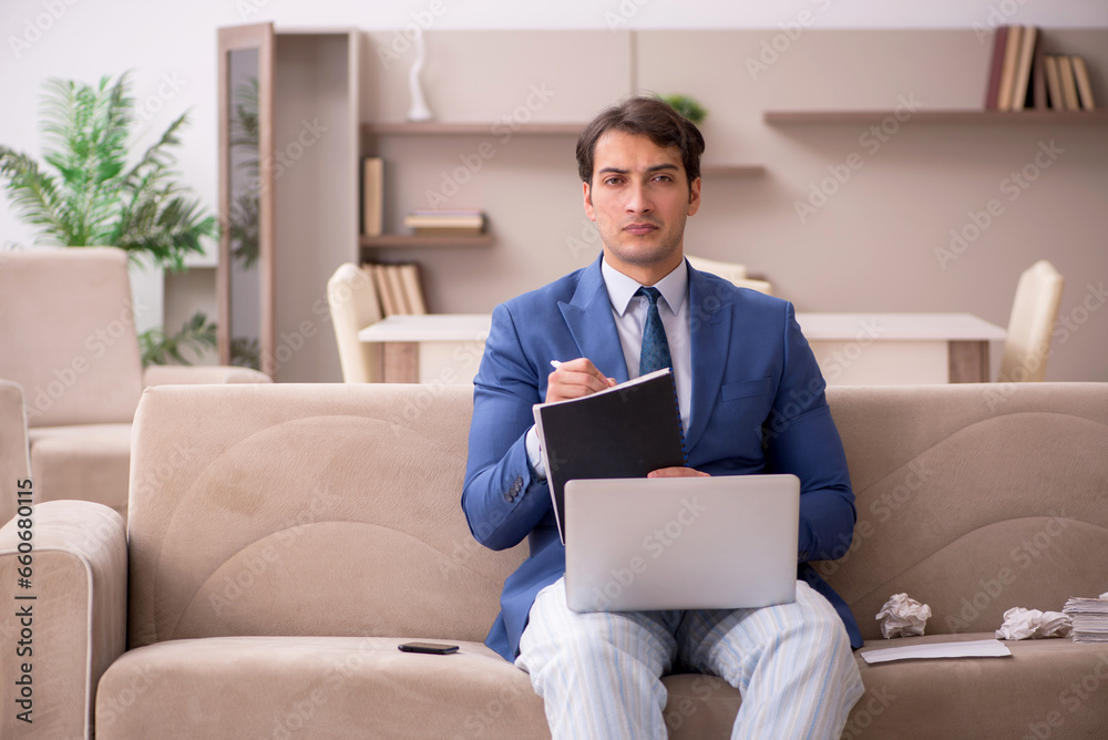 Young male employee working from home during pandemic Young male employee working from home during pandemic