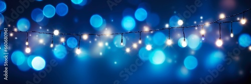 Christmas Bokeh Lights over Dark Blue Background. Holiday Illumination and Decoration Concept with Glowing Christmas Garland.