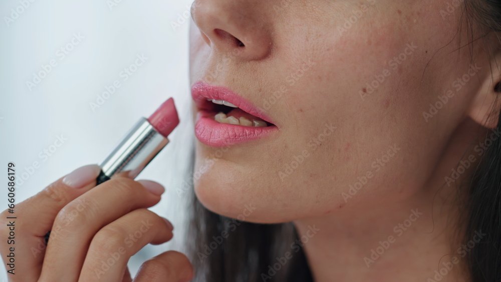 Closeup woman colouring lips at home. Happy smiling lady enjoying makeup care