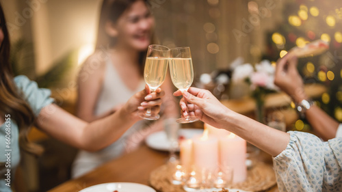 Closeup hands with glasses of champagne wine clink in christmas celebrate party festive.