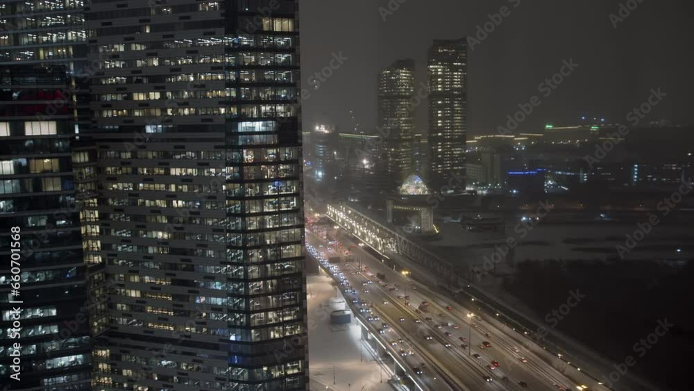 Cold windows of skyscraper in winter during a snowfall. Landscape of skyscrapers Cold windows of skyscraper in winter during a snowfall. Landscape of skyscrapers