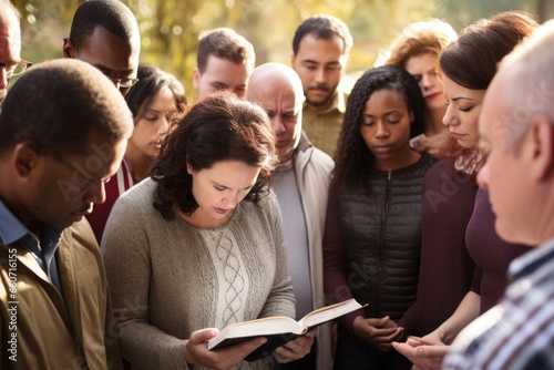 A group of believers, representing diverse languages and nationalities, standing together in prayer with a Bible open in the center of their circle.