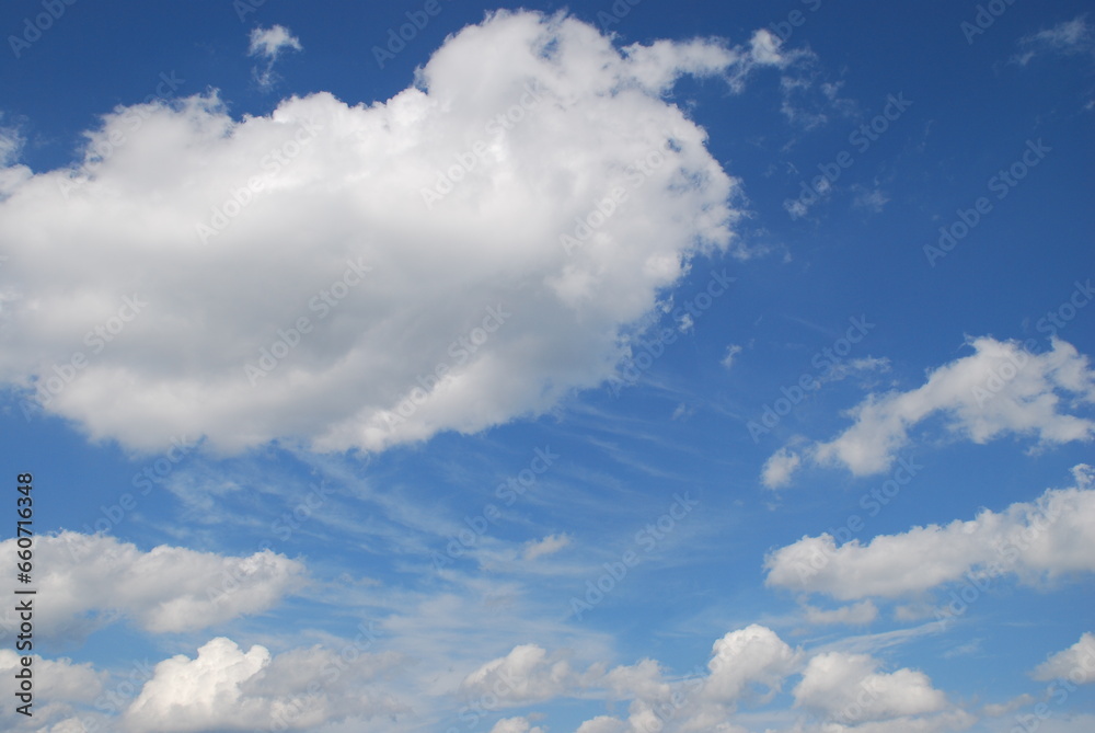 Overcast at different heights. Light blue sky, high cirrus clouds and low cumulus clouds float across the sky. Descent clouds are translucent, dense white cumulus clouds. Overcast at different heights. Light blue sky, high cirrus clouds and low cumulus clouds float across the sky. Descent clouds are translucent, dense white cumulus clouds.