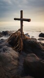 Concept photo of a rustic wooden cross standing on a rocky shoreline, with waves crashing against it, representing the power of forgiveness to weather lifes storms.