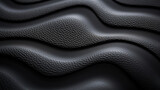 Closeup of a finegrained black rubber texture, almost velvetlike to the touch, with a matte finish.