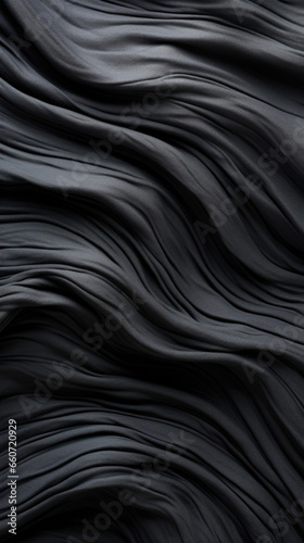 Closeup of a crinkled rubber texture, with wrinkles and folds creating a dynamic and tactile surface. The rubber is highly stretchable, able to bend and conform to different shapes without