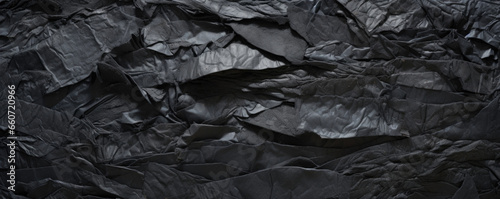 Texture of shredded and layered rubber, with intermingling fibers and a mix of smooth and rough surfaces. The torn rubber has a threedimensional quality, with areas of depth and texture.