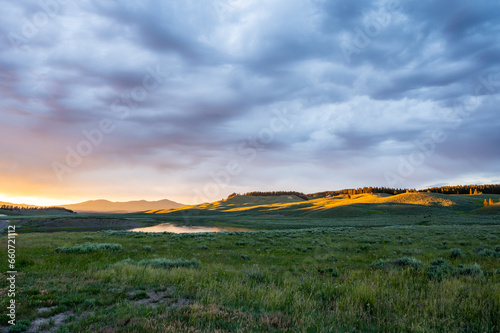 Thick Clouds Catch The Sunset Colors Over Hayden Valley and The Yellowstone River © kellyvandellen