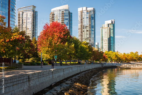 Downtown Vancouver modern Coal Harbor business district area high office and apartment buildings. Autumn Colors alone the Sea Walk in Stanley Park Vancouver BC Canada. Travel photo  street view