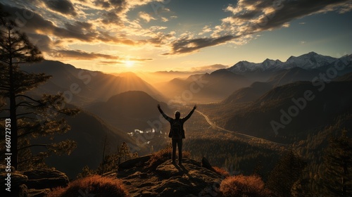 silhouette of a man standing on top of a mountain raising one hand to hit the sky no face photo