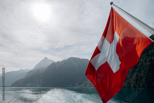 A Swiss flag at the stern of a passengers boat on the lake of Lucerne, Switzerland. photo