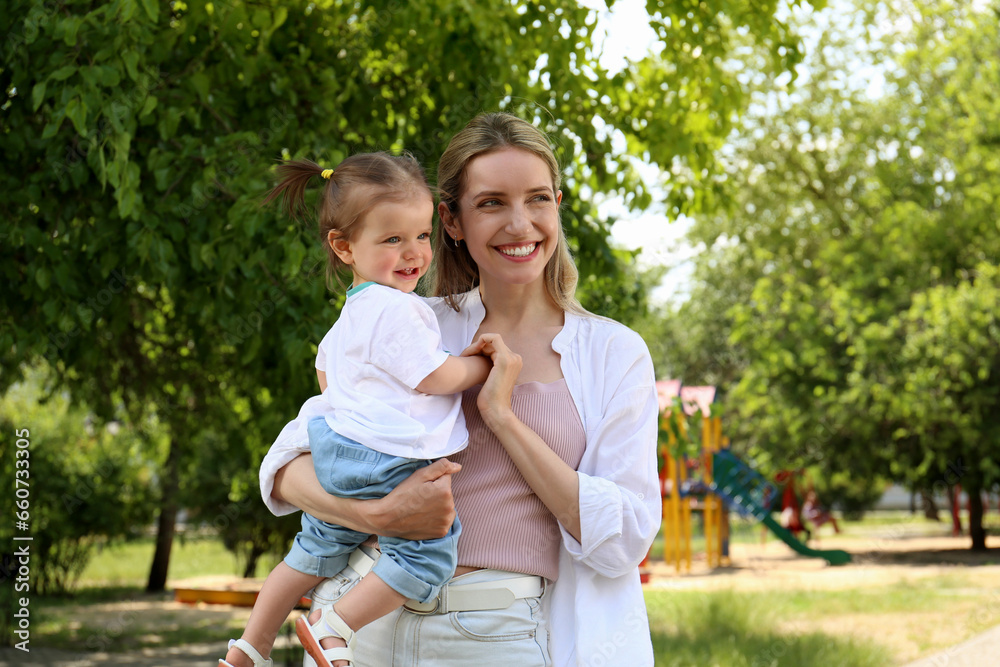 Happy mother with her daughter spending time together in park Happy mother with her daughter spending time together in park