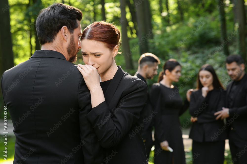 Sad people in black clothes mourning outdoors. Funeral ceremony Sad people in black clothes mourning outdoors. Funeral ceremony