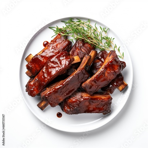 A plate of succulent BBQ ribs on a white background