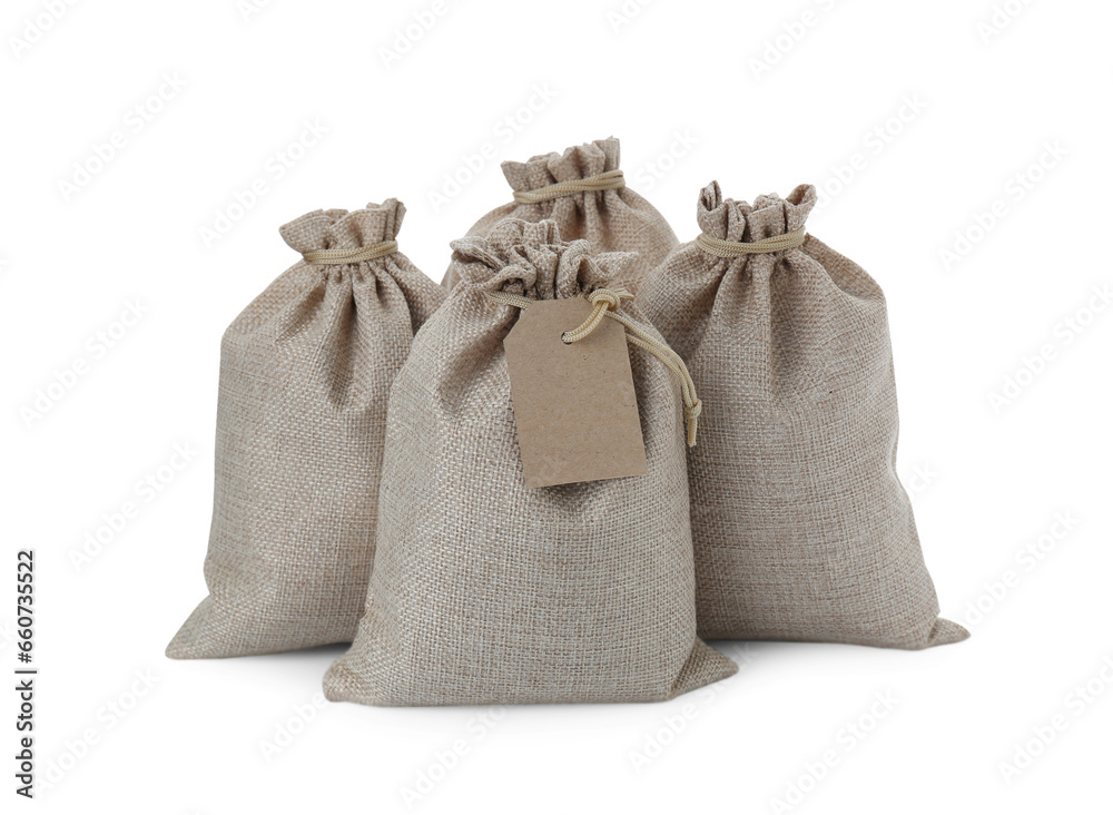 Many tied burlap bags isolated on white Many tied burlap bags isolated on white