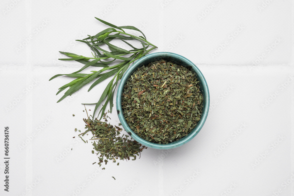 Dry and fresh tarragon on white tiled table, flat lay