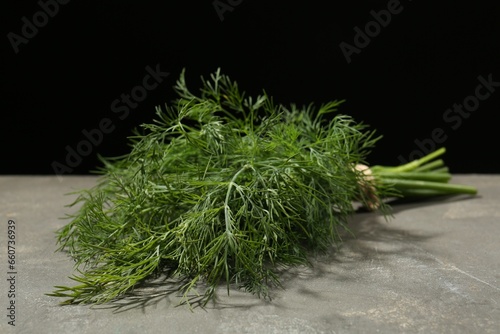 Bunch of fresh dill on grey table, closeup