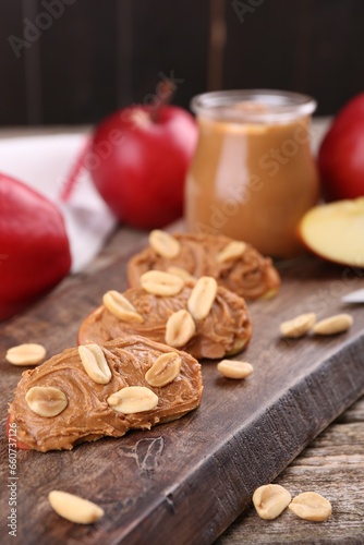 Pieces of fresh apple with peanut butter on table