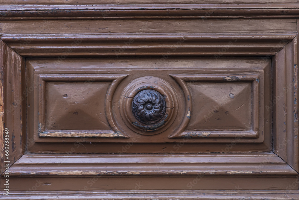 metal handle on access portal to a period building with a wooden door metal handle on access portal to a period building with a wooden door