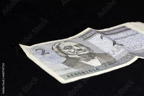 Selective blur on a banknote of 2 estonian Kroon (crown) isolated on a black background. The Kroon, or crown (EEK), was the official currency of the republic of Estonia before Euro. photo