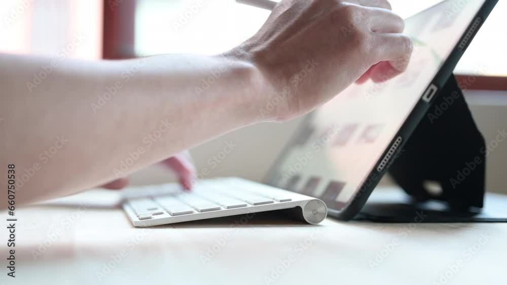 person using pen with digital tablet, typing on a laptop businessman working on computer keyboard person using pen with digital tablet, typing on a laptop businessman working on computer keyboard