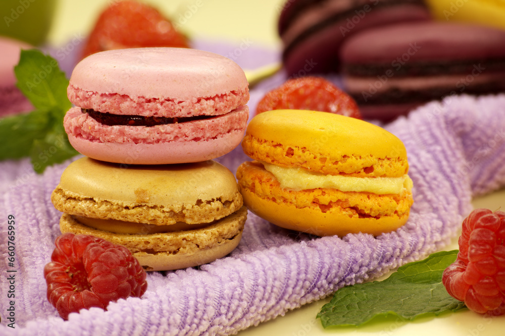 Stack of macaroons next to assortment of fruits