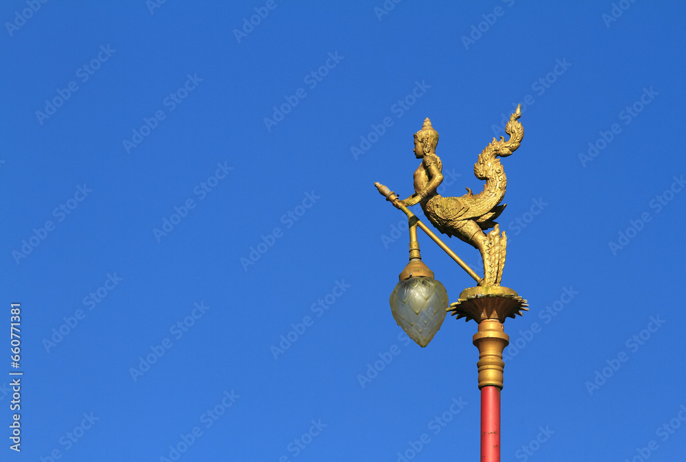 Gold lamps and lighting pole background with a blue sky,at Wat Ban Ngao (Temple), Ranong, Thailand Gold lamps and lighting pole background with a blue sky,at Wat Ban Ngao (Temple), Ranong, Thailand