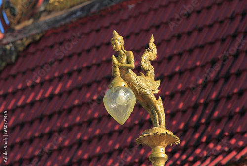 Gold lamps and lighting pole background with a blue sky,at Wat Ban Ngao (Temple), Ranong, Thailand