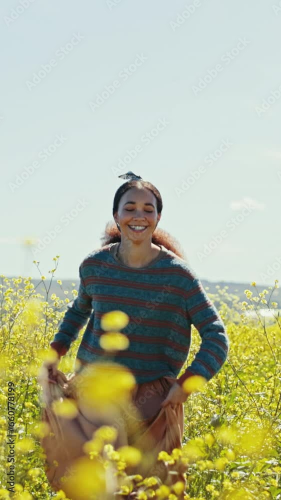 Happy woman, flower and field on adventure, travel and summer in countryside in grass. Vacation, running and freedom on holiday with smile and nature with female person run and sunshine on trip