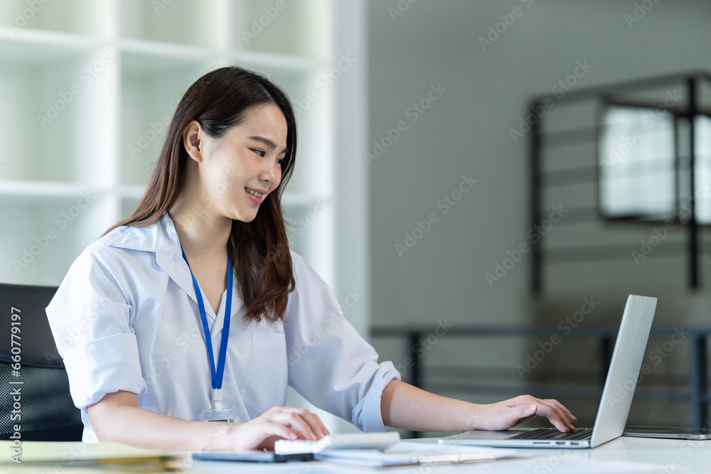 Businesswoman using a calculator to calculate numbers on a company's financial documents, she is analyzing historical financial data to plan how to grow the company. Financial concept