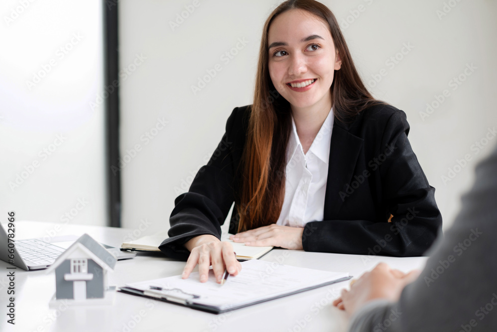 real estate agent with House model is talking to clients about buying home insurance. Home insurance concept real estate agent with House model is talking to clients about buying home insurance. Home insurance concept