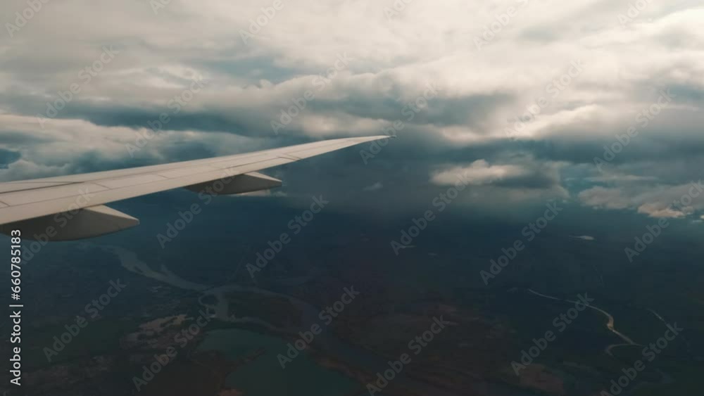 This stock video shows the wing of an airplane flying in the clouds. This video will decorate your projects related to travel, airplane flights, clouds. This stock video shows the wing of an airplane flying in the clouds. This video will decorate your projects related to travel, airplane flights, clouds.