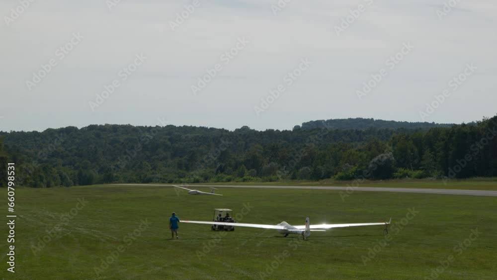 Glider (sailplane) ready for takeoff on an airfield in the hills. Glider (sailplane) ready for takeoff on an airfield in the hills.