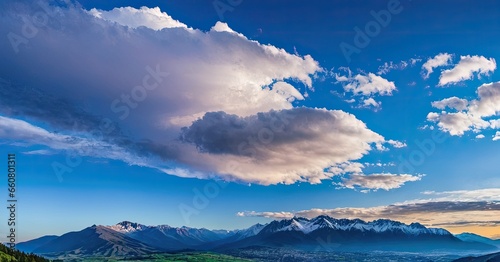 A beatiful sky with comolus clouds and a mountain range in the background