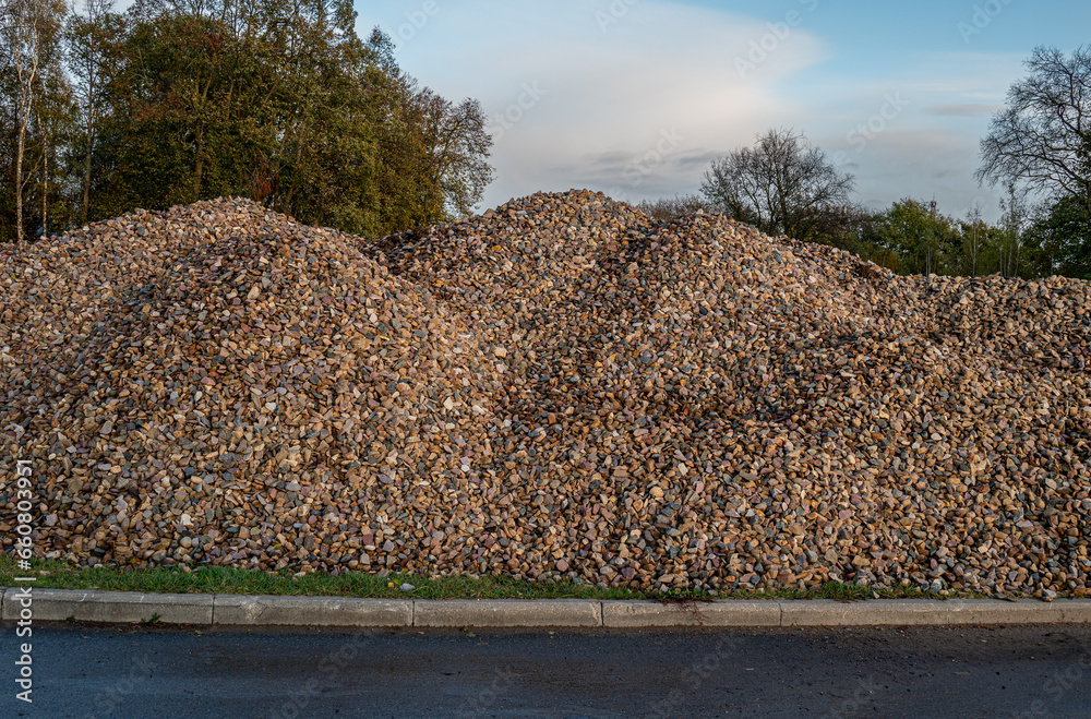 A pile of rubble for construction and repair on a city street. Industrial background.