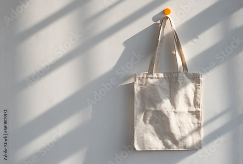 Textile shopping bag hanging from hook.